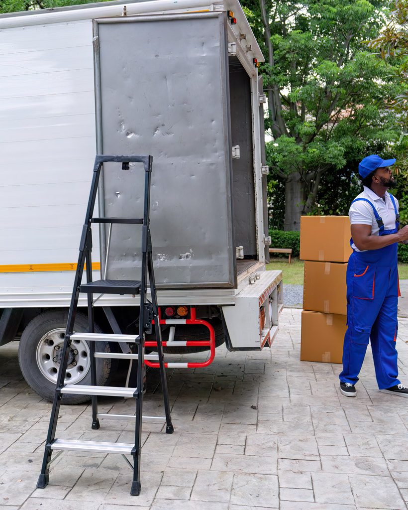 Delivery house move cargo truck service man checking box list from digital tablet for signature Delivery house move cargo truck service man checking box list from digital tablet for signature